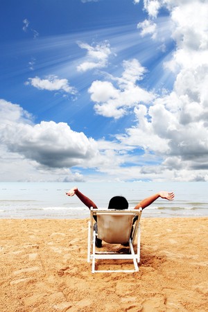 Business man relax on deck at the beach