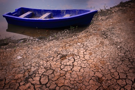 plastic boat on dry soilの写真素材