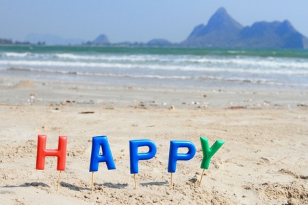 Alphabet  forming the word happy and sea view backgroundの写真素材