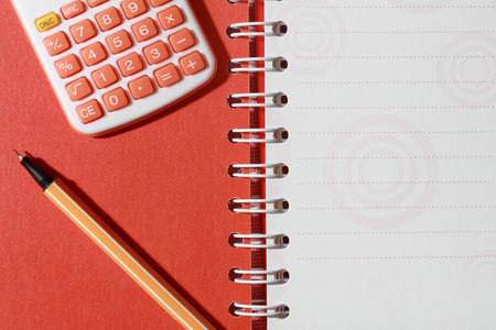 Calculator and pen on open note book