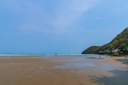 The sea and the beach with beautiful mountains under the blue sky.