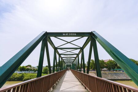 A pedestrian bridge over the Pa Sak River at Satue Temple, Ayutthaya Province in Thailandの写真素材