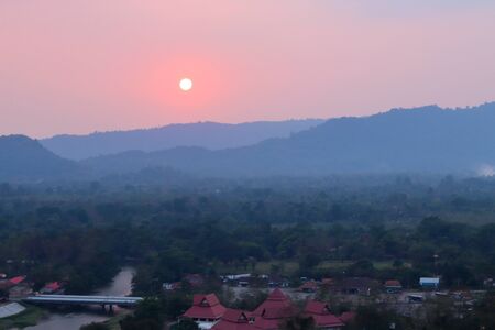 The sunset behind the dark mountains and the beautiful nature backdrop.の写真素材