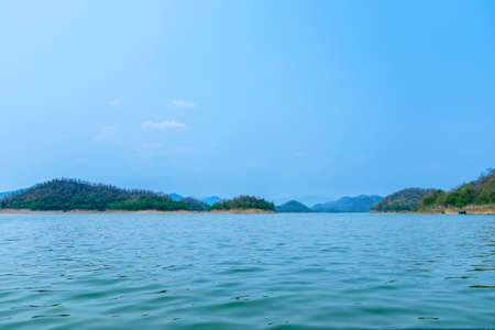 The lake scenery with mountains behind under the blue skyの写真素材