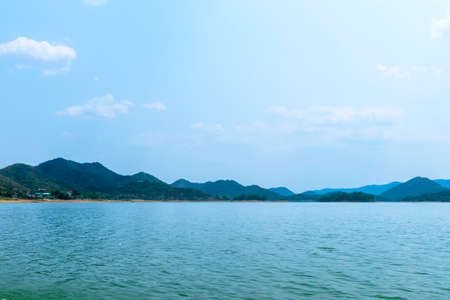 The lake scenery with mountains behind under the blue skyの写真素材