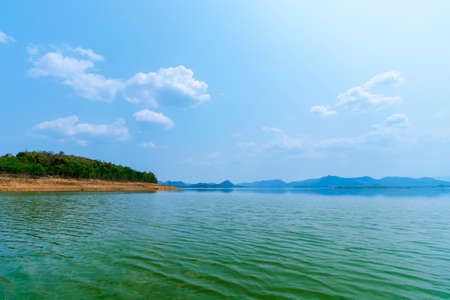 The lake scenery with mountains behind under the blue skyの写真素材