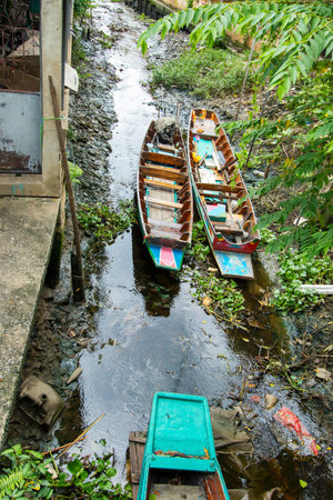 Two wooden boats moored in a natural canal.