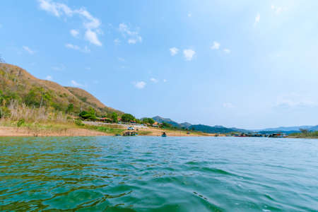 The lake scenery with mountains behind under the blue skyの写真素材