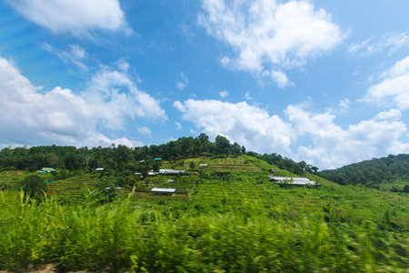 The mountains against the blue cloudy sky in the background