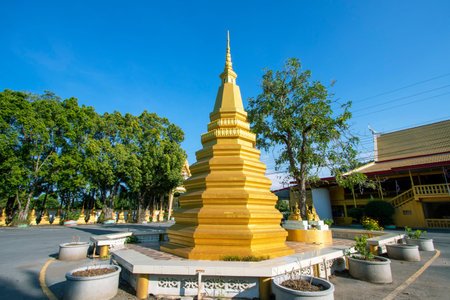 Beautiful golden yellow pagoda at Phra Prang Muni temple in Sing Buri province in Thailand.