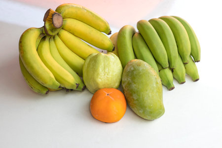 Bananas and various fruits are isolated on a white background.