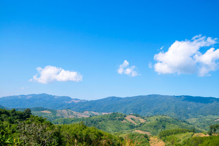 Nature views, mountains and trees under a bright northern sky in Thailand.