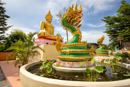 Big golden Buddha statue at a Buddhist temple in Thailandの写真素材