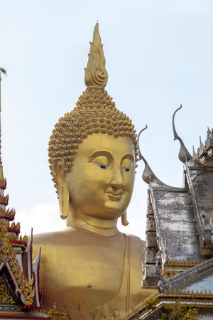 A large golden yellow Buddha image at Wat Muang, an important religious attraction in Ang Thong Province in Thailand.の写真素材