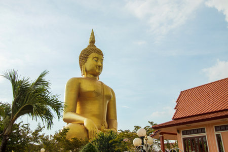 A large golden yellow Buddha image at Wat Muang, an important religious attraction in Ang Thong Province in Thailand.の写真素材