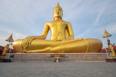 A large golden Buddha image sits along the Chao Phraya River at Wat Bang Chak in Nonthaburi Province in Thailand.の写真素材