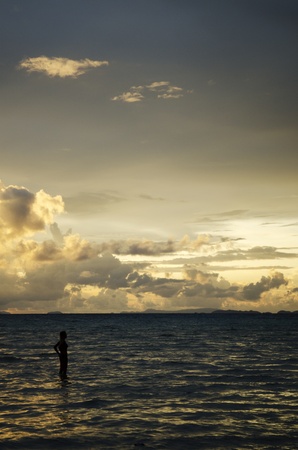 tropical sunset with tourist womanの写真素材