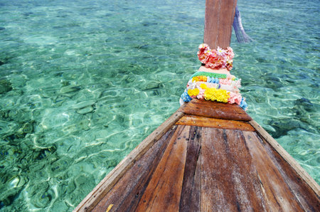 turquoise tropical island sea water and thai boat
