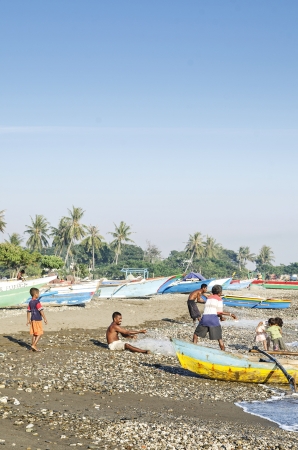 fishermen working on beach in dili east timorのeditorial素材