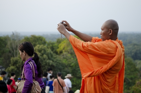 buddhist monk and tourists in angkor wat cambodiaのeditorial素材