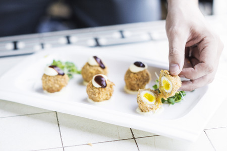 scotch breaded eggs  contemporary fusion style being served in gourmet restaurantの写真素材