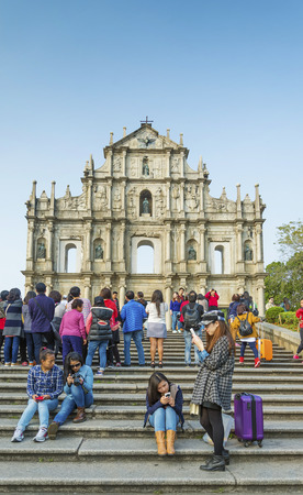 tourists using mobile phones at ruins of st paul landmark in macau chinaのeditorial素材