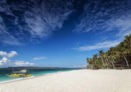 traditional filipino asian ferry taxi tour boats on puka beach in tropical boracay philippinesのeditorial素材