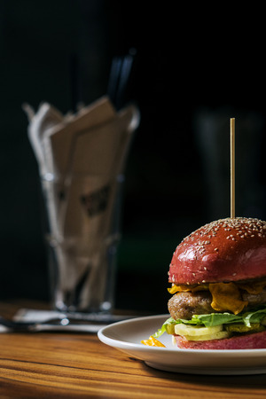 modern gourmet trendy chicken burger in beetroot bunの写真素材