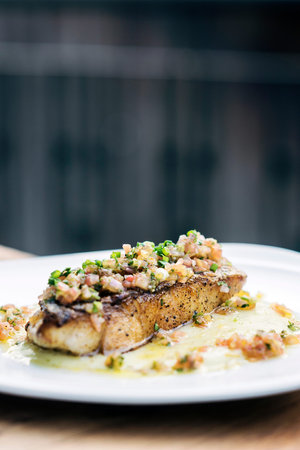 fresh sea fish fillet with spicy salsa vegetables sauce
