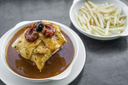 famous francesinha traditional meat cheese and spicy sauce grilled sandwich of porto portugalの写真素材