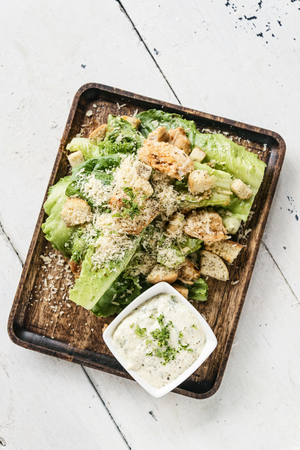 classic famous caesar salad with cream dip setの写真素材