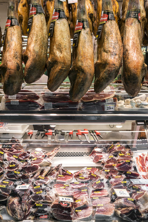 traditional spanish cured meats and sausages on display at la boqueria market deli in barcelona spainのeditorial素材