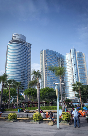 riverside pdestrian promenade park and skyscrapers in downtown xiamen city chinaのeditorial素材