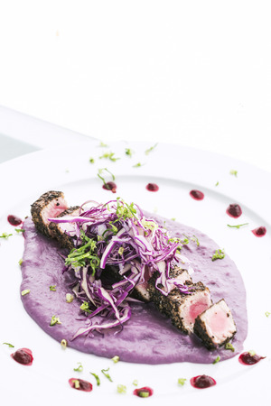 Modern fusion gourmet food cuisine seared tuna fish meal with beetroot sauceの写真素材