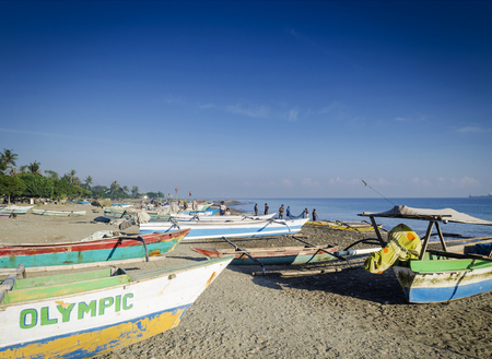 coast with traditional fishing boats on dili beach in east timor lesteのeditorial素材