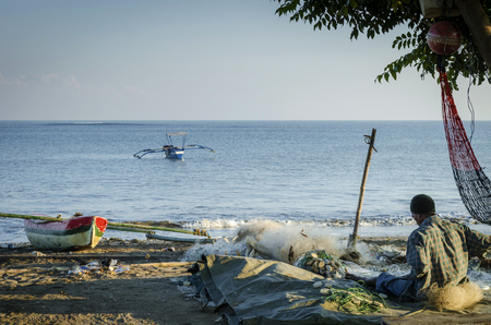 coast with traditional fishing boats on dili beach in east timor lesteのeditorial素材