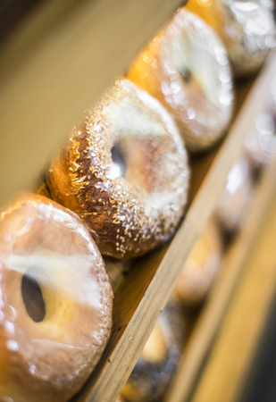 mixed fresh organic bagels in modern bakery displayの写真素材