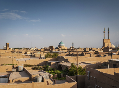rooftops downtown mosque and landscape view of yazd city old town in iranの写真素材