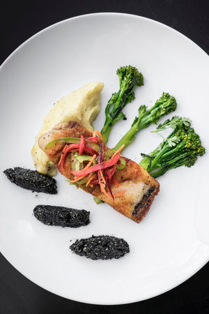 red snapper fish fillet with vegetables and black rice with black sesame seeds asian modern fusion...