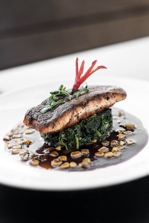 salmon fillet with steamed spinach and corn with sweet soy  and oyster sauceの写真素材
