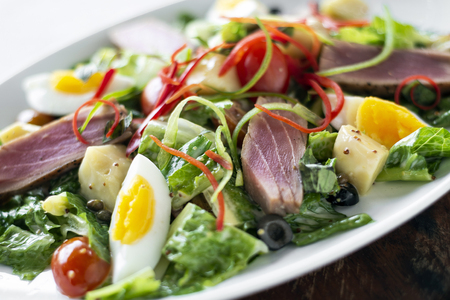 fresh seared raw tuna fish and mixed vegetable salad with mustard sauceの写真素材