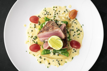 fresh seared tuna steak with creamy mustard and kampot pepper sauceの写真素材