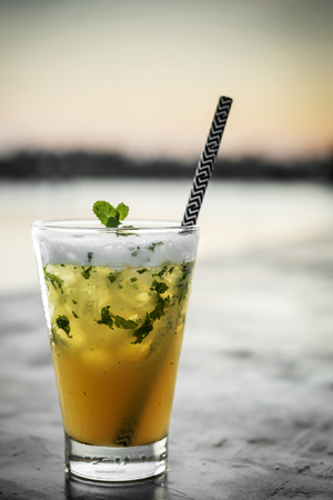 passion fruit mojito mixed cocktail drink with zesty egg white foam in riverside bar of vientiane laosの写真素材