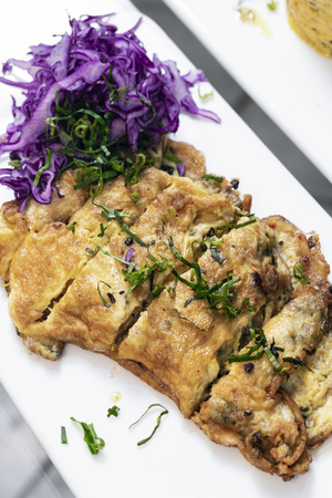 spicy chorizo and mushroom omelette with red cabbage salad tapas snack in lisbon restaurantの写真素材
