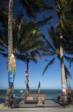 bolabog beach view with surf board and palm trees in tropical paradise boracay island philippinesのeditorial素材