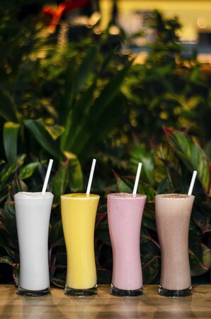 mixed organic coconut, strawberry, chocolate and mango ice cream milk shakesの写真素材