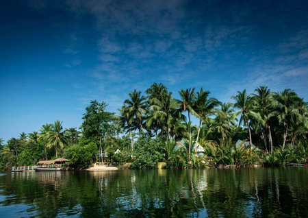 traditional jungle ferry boat at pier on tatai river in cambodiaのeditorial素材