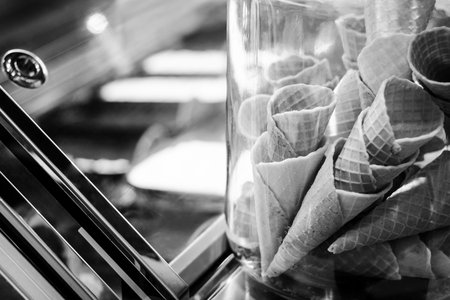 traditional italian gelato ice cream wafer cones in shop display black and white detail