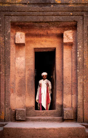 coptic orthodox priest at lalibela ancient rock-hewn monolithic churches landmark UNESCO heritage site in ethiopiaのeditorial素材
