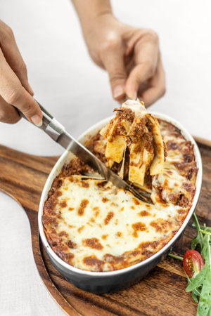 fresh beef lasagna in traditional oven dish on table in rome italy restaurant